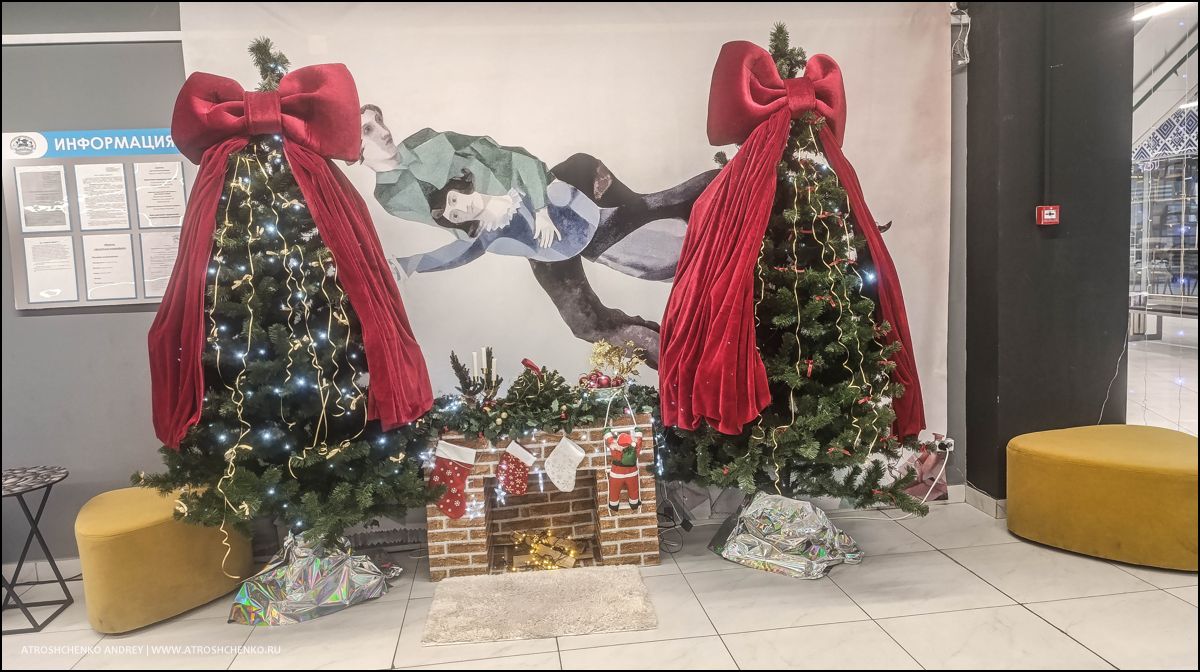 Фотозона с рождественскими санями и елками внутри гипермаркета Перши